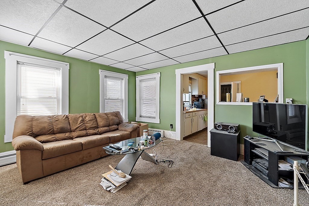 11 Autumn Street Lowell, MA 01852 - Photo 21 of 35 a living room with furniture a flat screen tv and a window