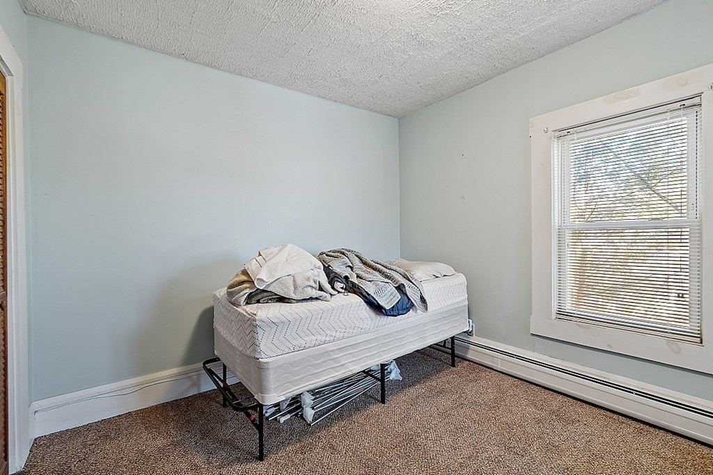 11 Autumn Street Lowell, MA 01852 - Photo 26 of 35 a bedroom with a bed and window