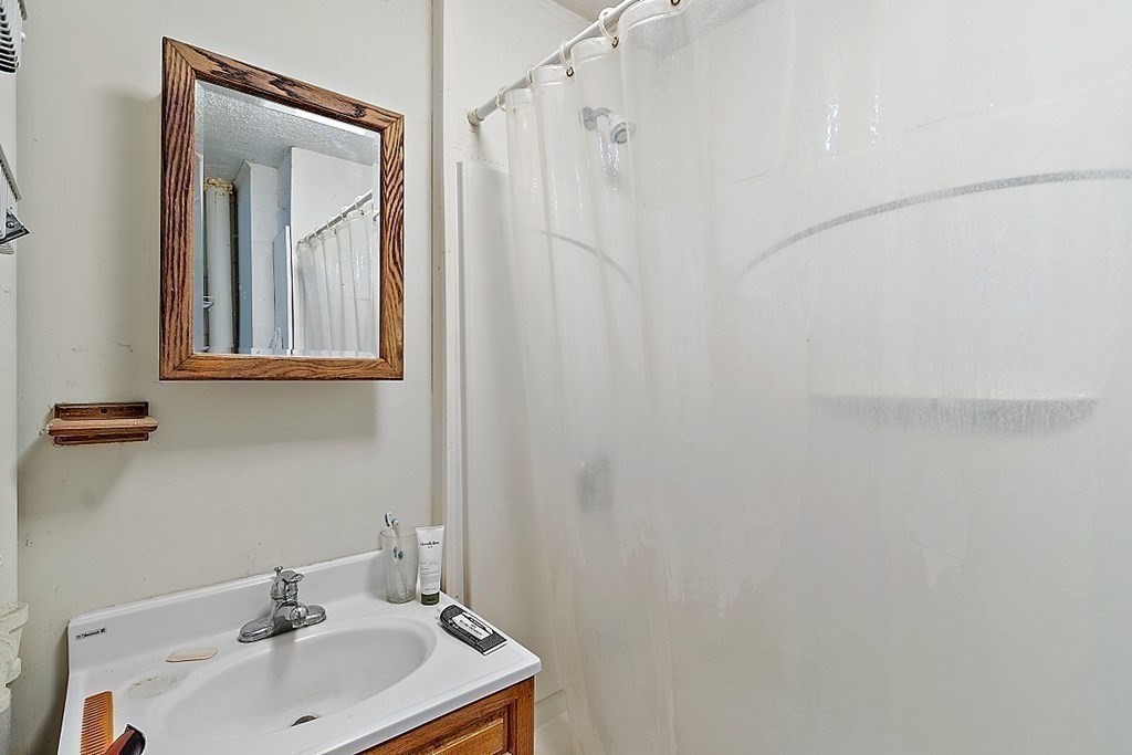 11 Autumn Street Lowell, MA 01852 - Photo 30 of 35 a bathroom with a sink and mirror