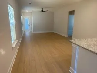 a view of a hallway with wooden floor