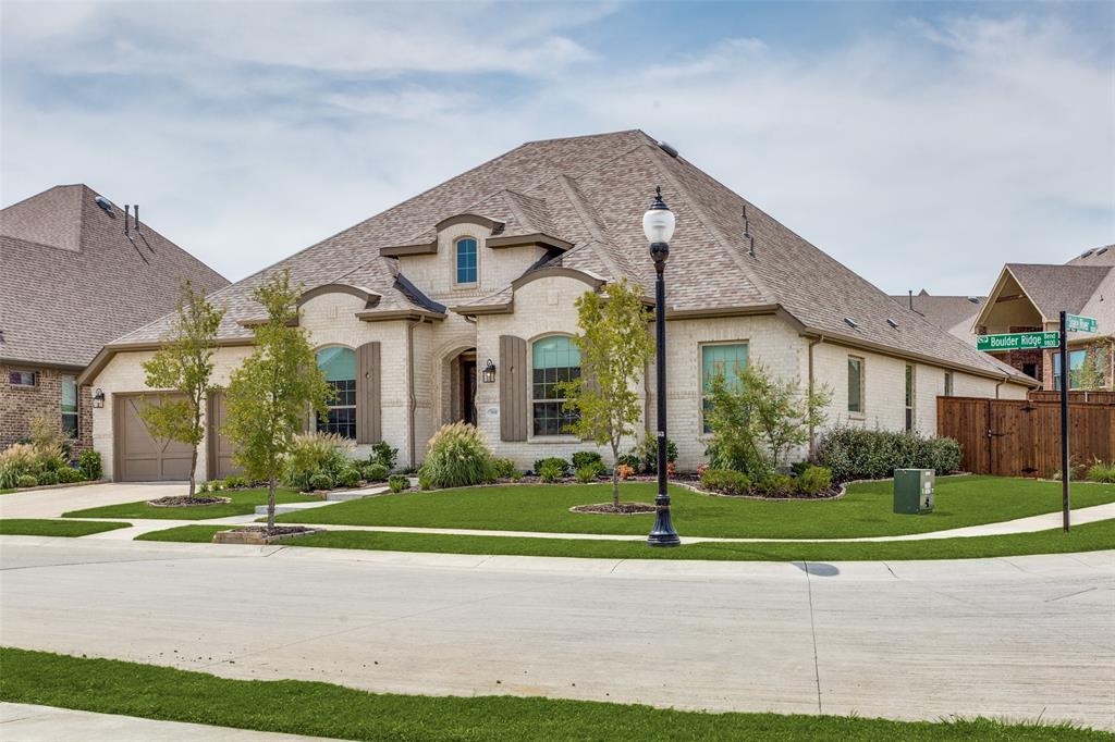 9800 Boulder Ridge Bend Oak Point, TX 75068 - Photo 1 of 1 a view of a white house with a yard and plants
