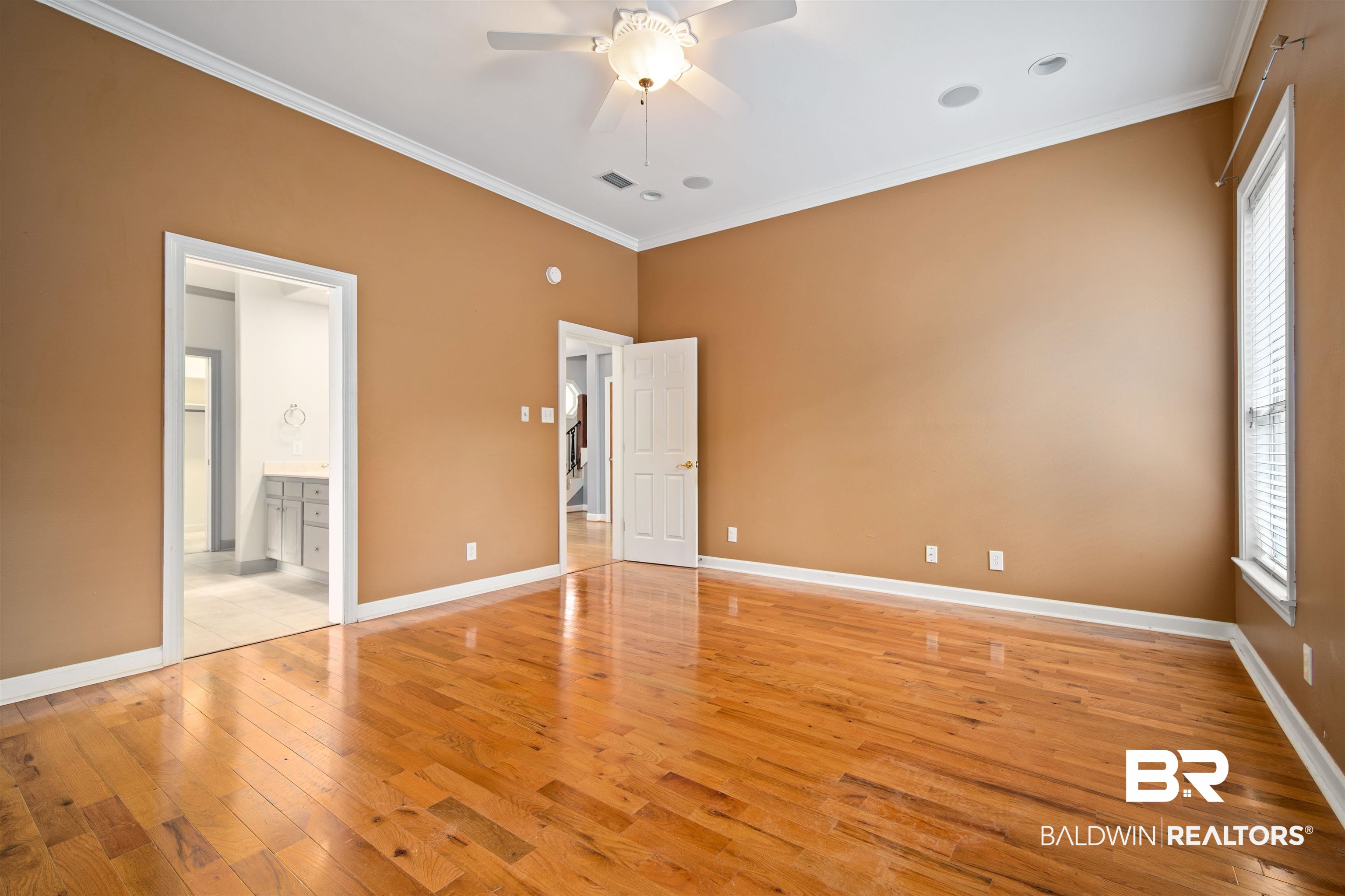 204 General Canby Loop Daphne, AL 36527 - Photo 18 of 36 Unfurnished bedroom featuring crown molding, ensuite bath, light wood-type flooring, and ceiling fan