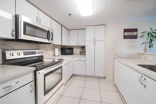 a kitchen with stainless steel appliances granite countertop a sink and a stove