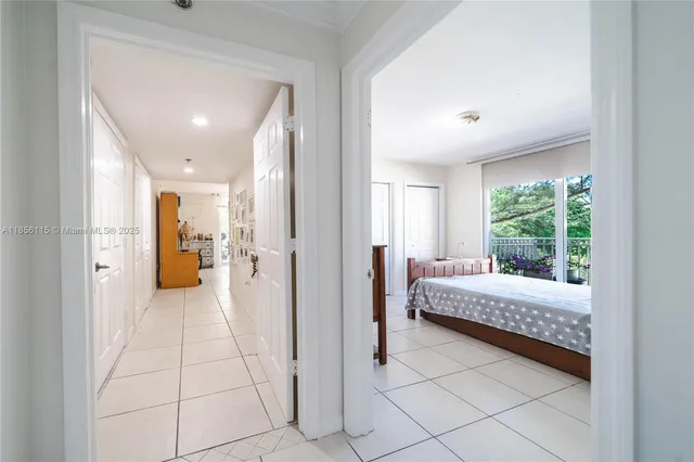 a view of a bedroom with a bed and glass door