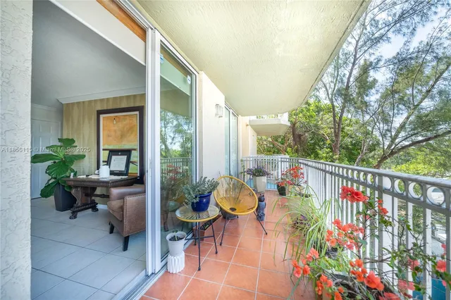 a balcony with furniture and potted plants
