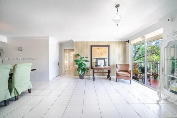 a living room with furniture a flat screen tv and a floor to ceiling window