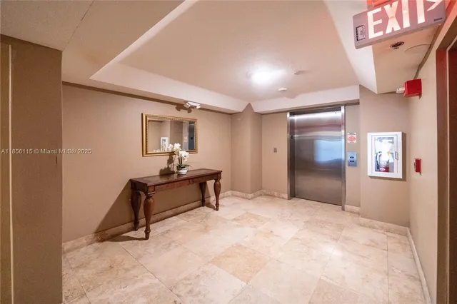 a view of hallway with window and a refrigerator