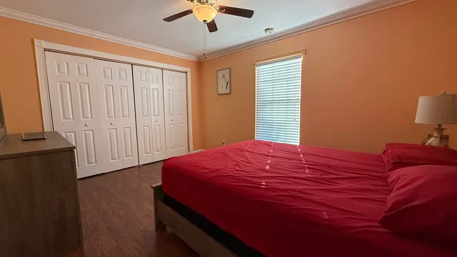 a bedroom with a bed and a chandelier