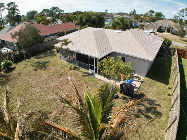 a view of a house with a yard and sitting area