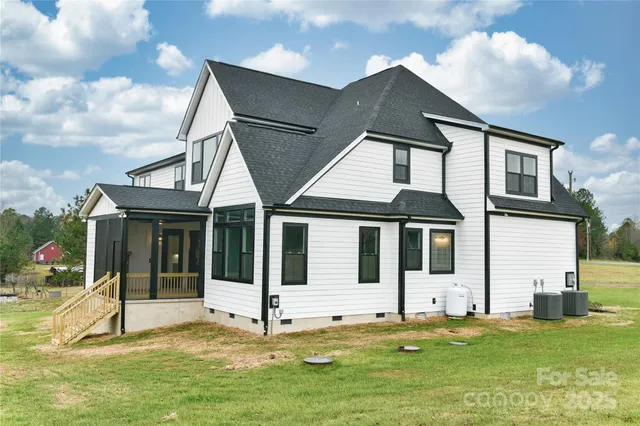 a backyard of a house with yard table and chairs