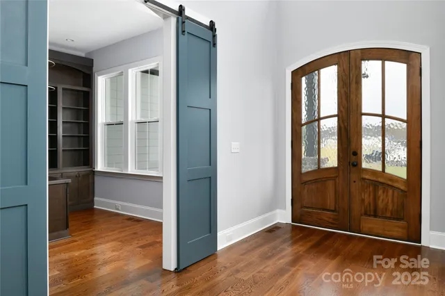an empty room with windows and closet