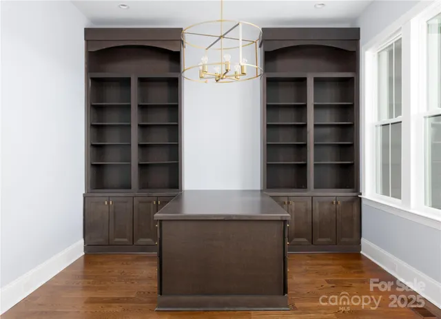 a living room with cabinets and a potted plant