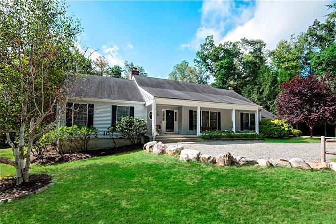 25 Topstone Road Ridgefield, CT 06877 - Photo 1 of 1 a front view of house with yard and green space