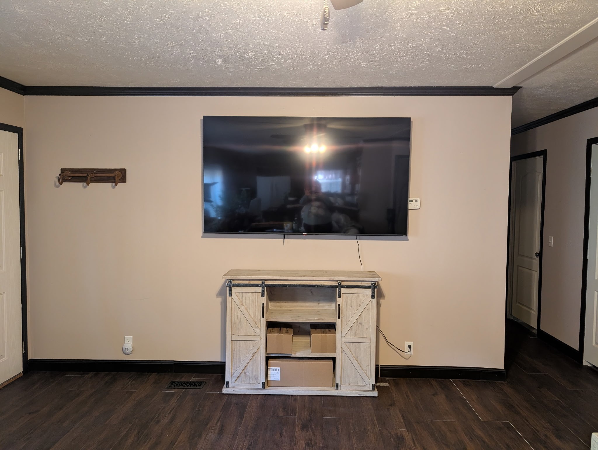 1239 Bald Knob Road Holladay, TN 38341 - Photo 11 of 25 a living room with a flat screen tv a fireplace and wooden floor