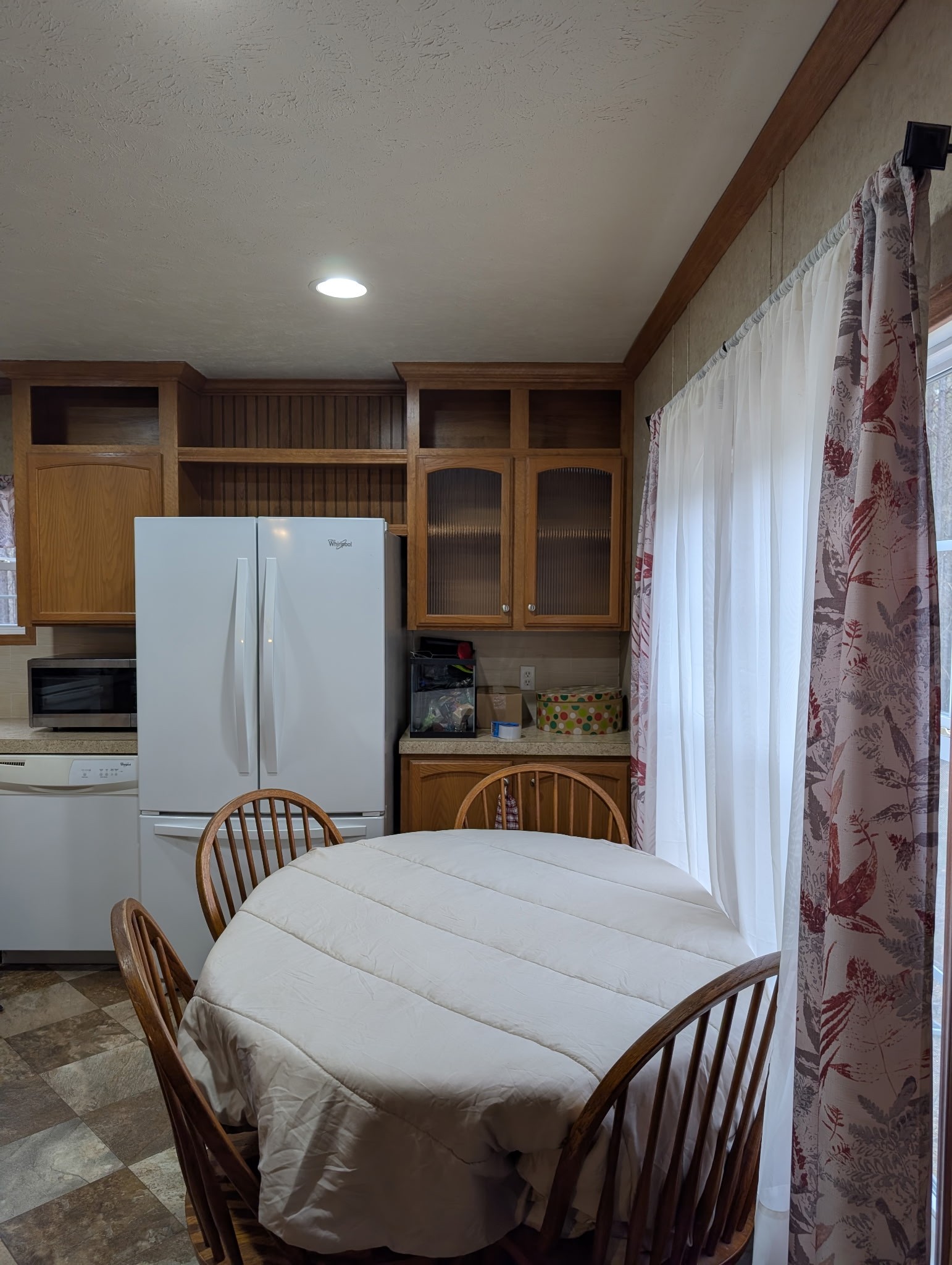 1239 Bald Knob Road Holladay, TN 38341 - Photo 14 of 25 a kitchen with a table chairs and a refrigerator