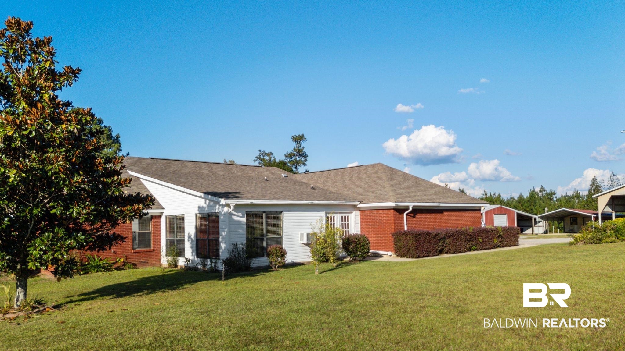 888 Mobile Cut-Off Road St. Stephens, AL 36569 - Photo 41 of 54 View of front facade with a front yard, brick siding, a garage, and concrete driveway