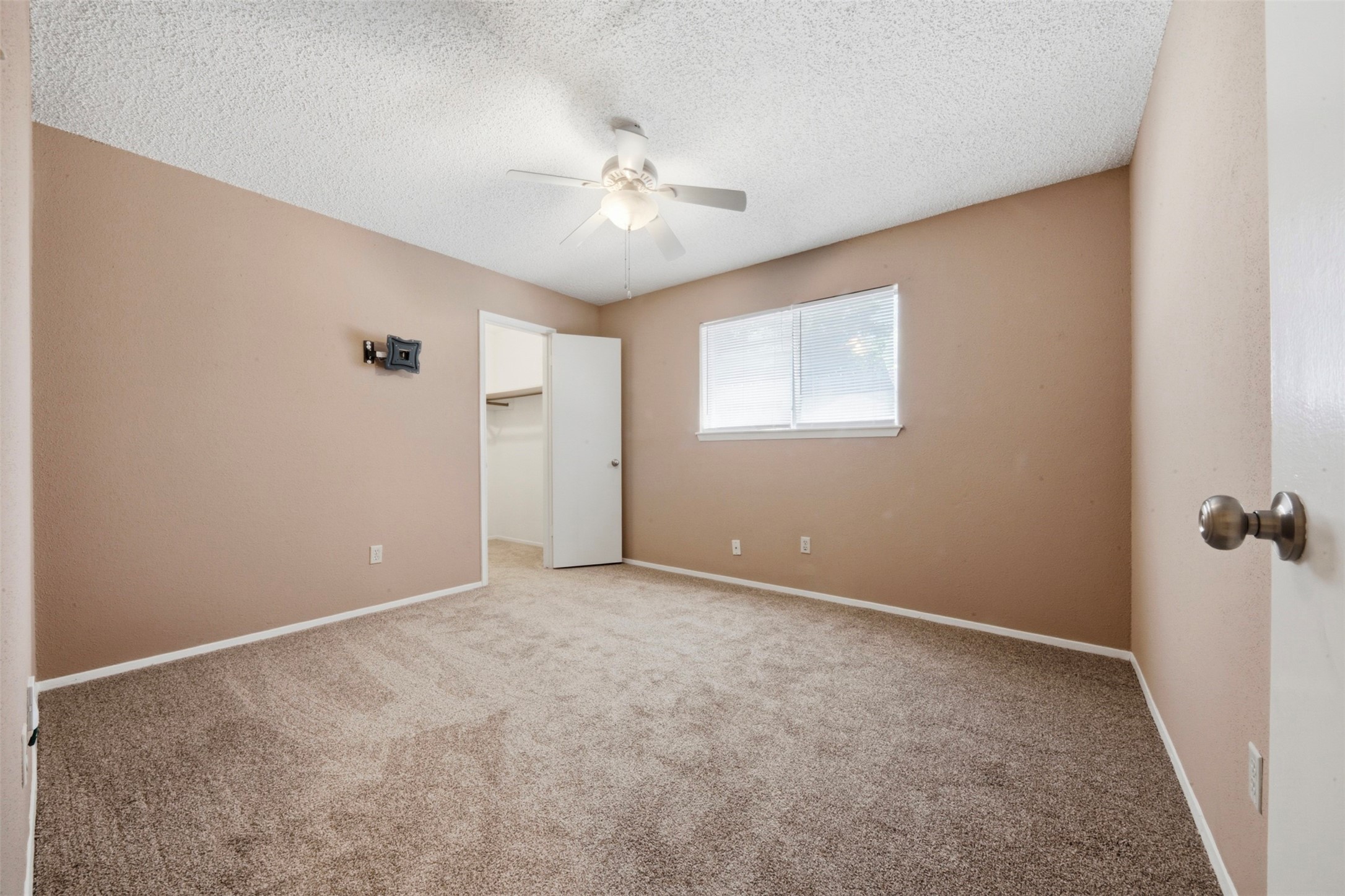 4019 Postwood Drive Spring, TX 77388 - Photo 28 of 50 an empty room with a chandelier fan and windows