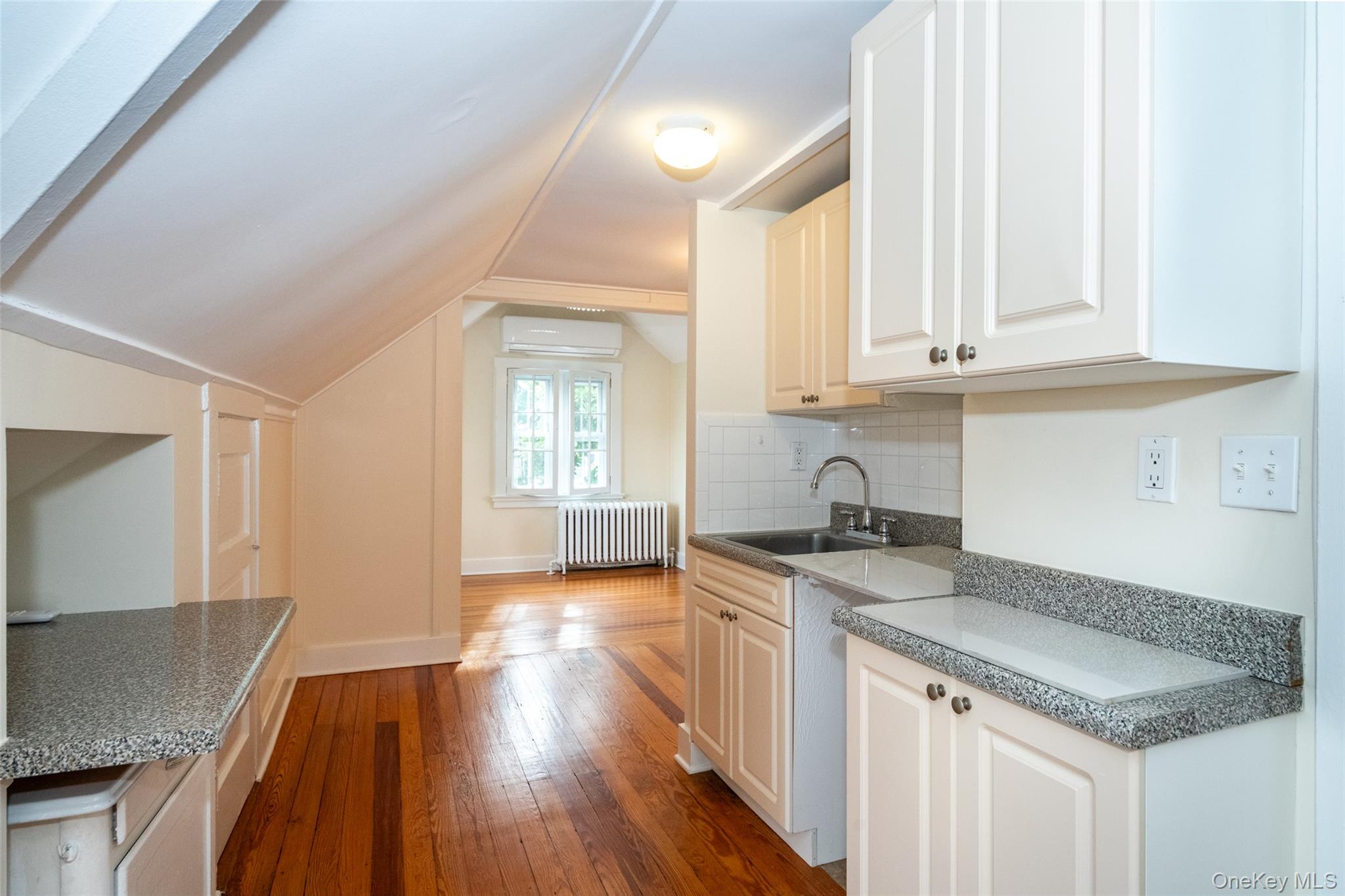 82 Clove Road New Rochelle, NY 10801 - Photo 23 of 39 a kitchen with granite countertop a sink stove and cabinets