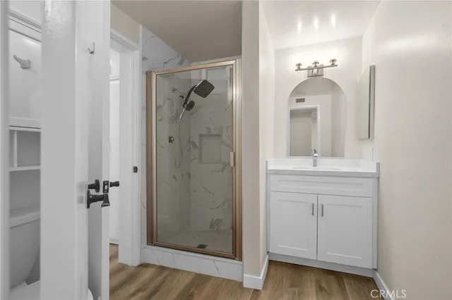 a bathroom with a shower sink and mirror