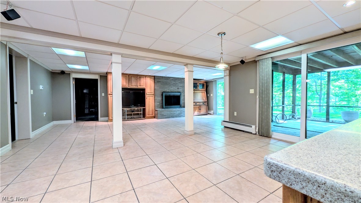 6409 Old Woods Road Ashtabula, OH 44004 - Photo 23 of 43 Spacious room featuring light-toned tile flooring, a drop ceiling with integrated lighting, and multiple structural columns