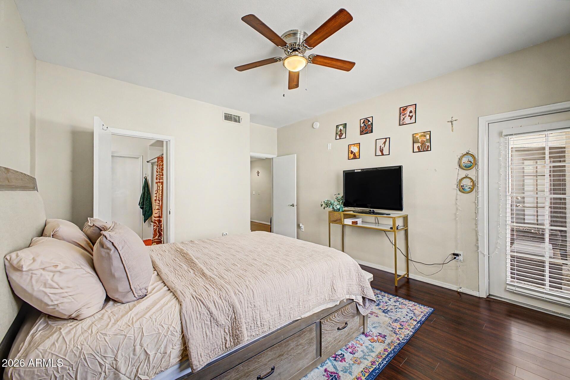 3302 North 7th Street, Unit 354 Phoenix, AZ 85014 - Photo 12 of 32 a bedroom with a bed and a flat screen tv