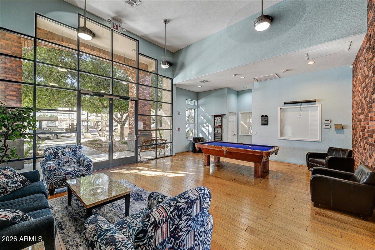 3302 North 7th Street, Unit 354 Phoenix, AZ 85014 - Photo 25 of 32 a living room with furniture a pool table and a large window