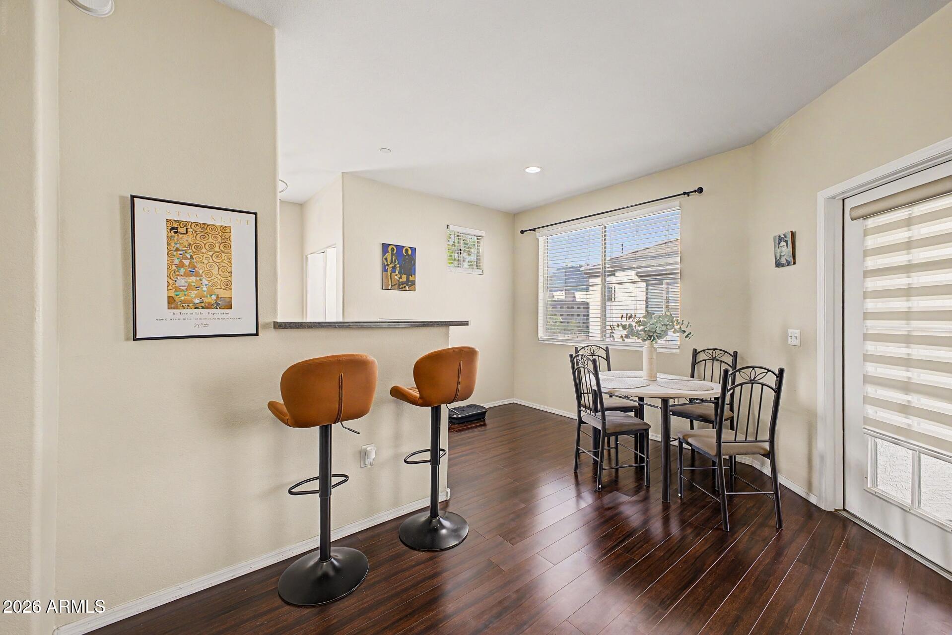3302 North 7th Street, Unit 354 Phoenix, AZ 85014 - Photo 8 of 32 a view of a dining room with furniture and wooden floor