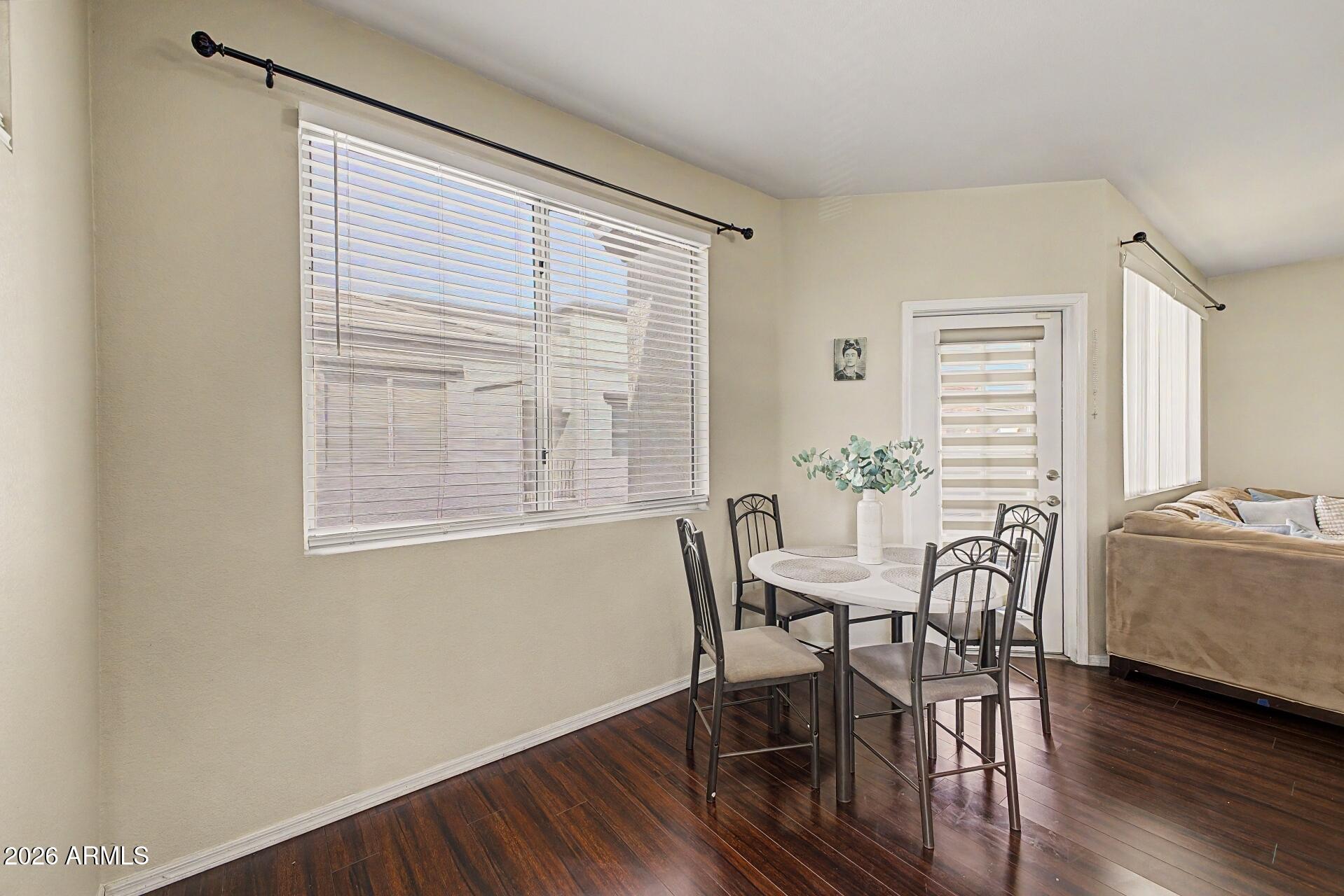 3302 North 7th Street, Unit 354 Phoenix, AZ 85014 - Photo 9 of 32 a view of a dining room with furniture and wooden floor