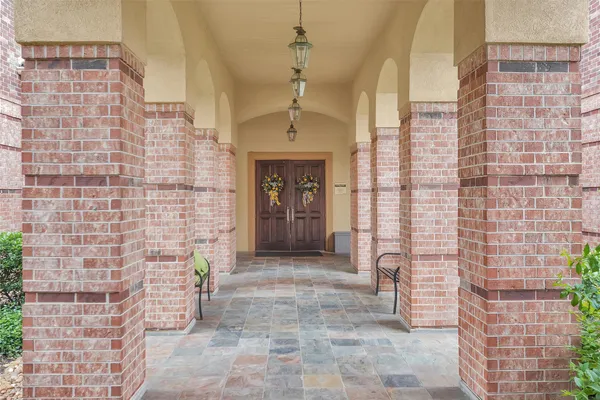 a front view of a house with swimming pool and porch