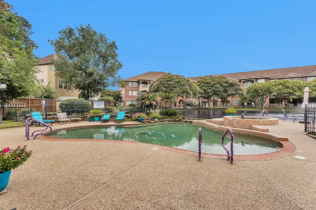 a front view of a house with swimming pool and porch