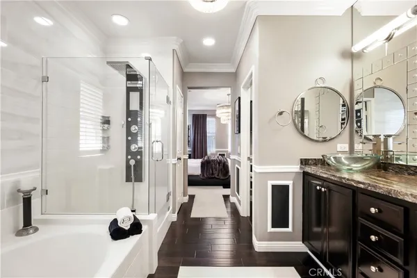 a bathroom with a double vanity sink a mirror and shower