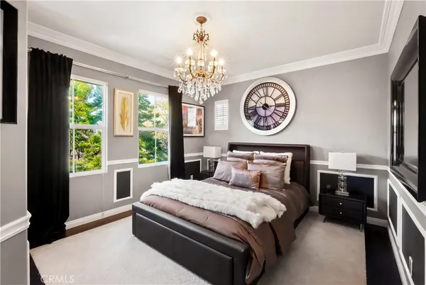 a bedroom with a bed and a chandelier