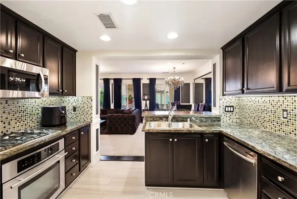 a kitchen with stainless steel appliances granite countertop a sink and stove