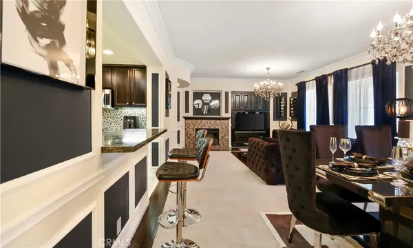 a kitchen with stainless steel appliances granite countertop a refrigerator a stove and a sink with wooden floor