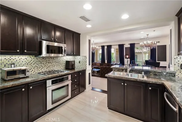 a kitchen with stainless steel appliances granite countertop counter space a sink and cabinets