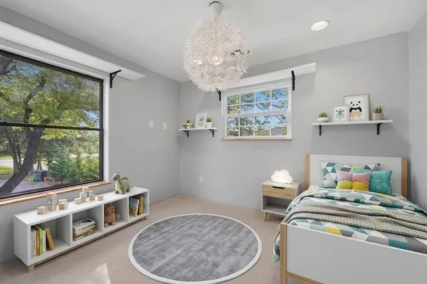 a bedroom with furniture and a window
