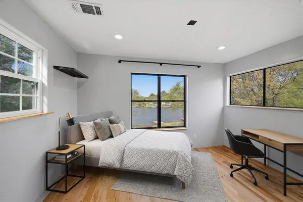 a bedroom with a bed window and table