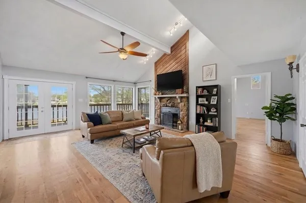 a living room with fireplace furniture and a wooden floor