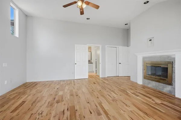 a big room with closet and a fireplace