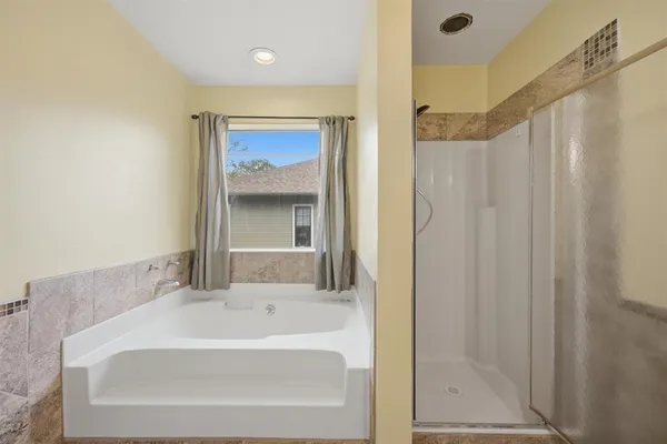 a bathroom with a bathtub and shower