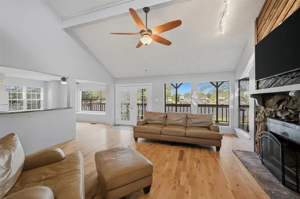 a living room with furniture flat screen tv and a fireplace