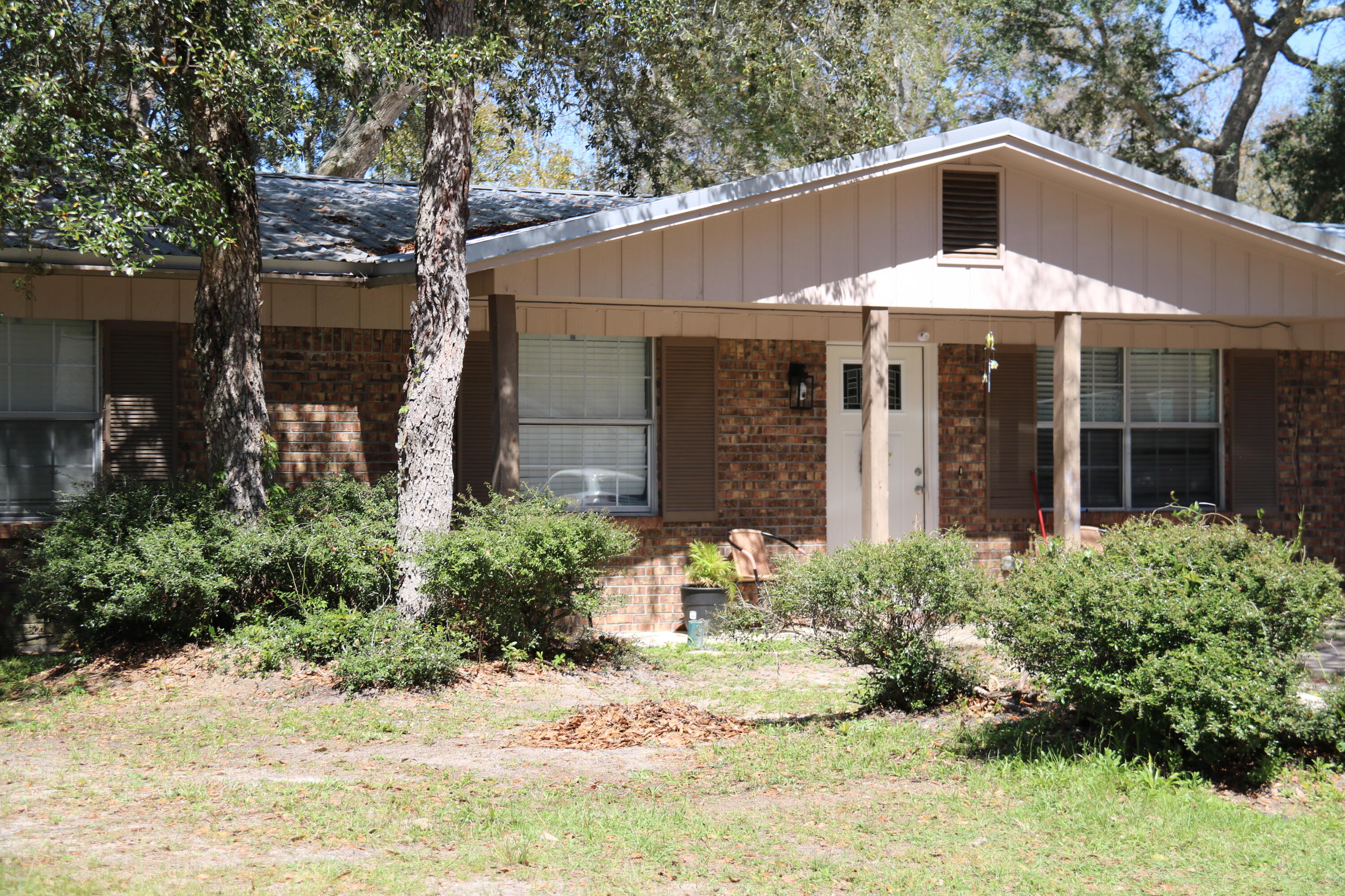 412 Bear Road Fort Walton Beach, FL 32547 - Photo 2 of 3 a front view of a house with garden