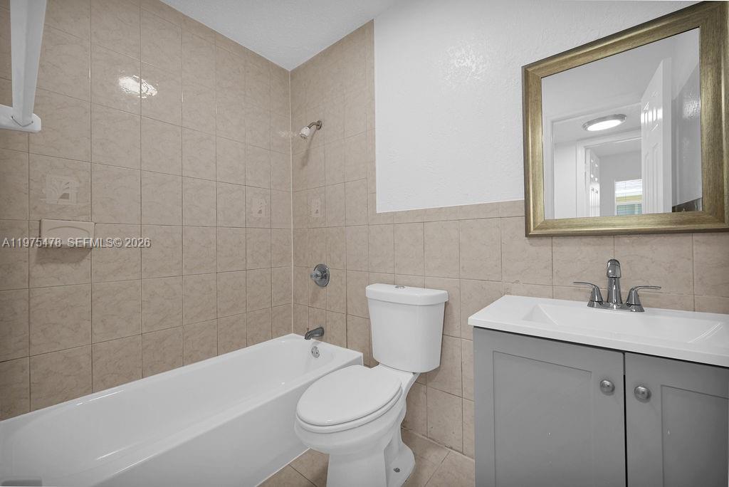 666 Kathy Court Pompano Beach, FL 33068 - Photo 16 of 45 a bathroom with a sink a toilet and shower