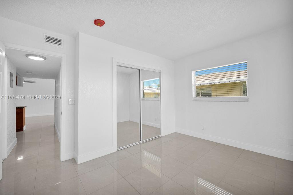666 Kathy Court Pompano Beach, FL 33068 - Photo 19 of 45 an empty room with windows and entrance