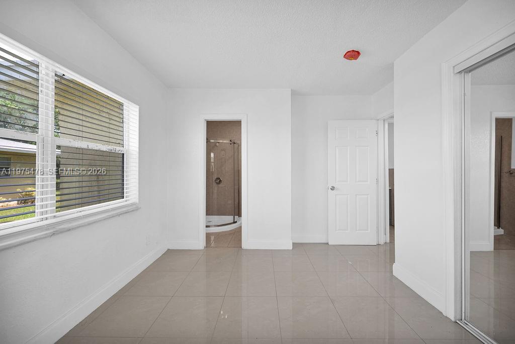 666 Kathy Court Pompano Beach, FL 33068 - Photo 20 of 45 a view of an empty room with a window