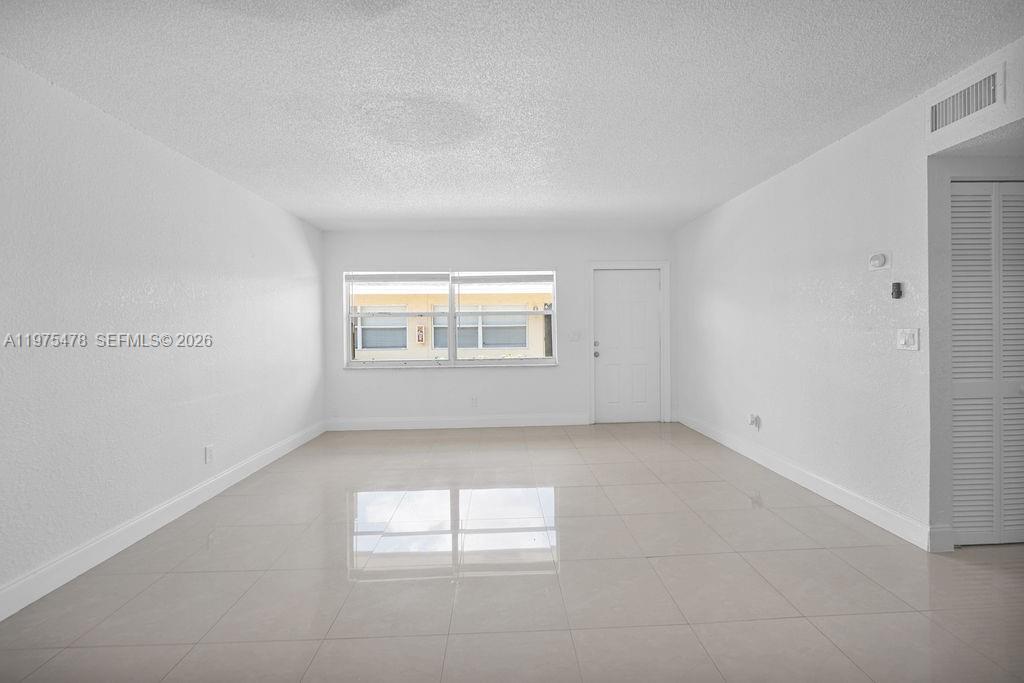 666 Kathy Court Pompano Beach, FL 33068 - Photo 2 of 45 an empty room with a empty space and windows