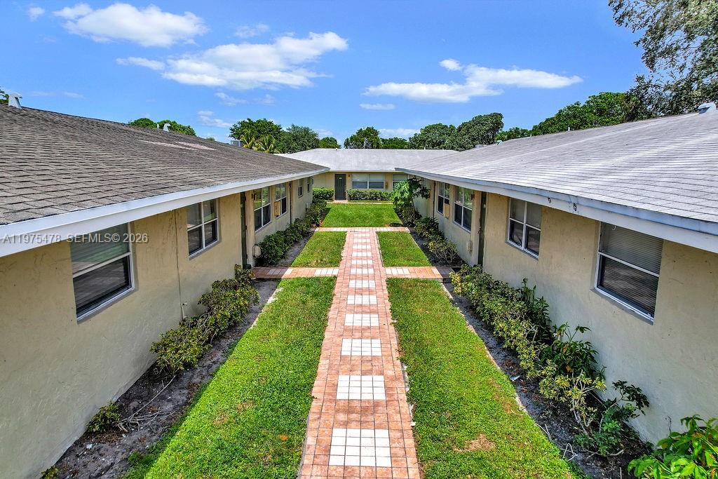 666 Kathy Court Pompano Beach, FL 33068 - Photo 28 of 45 a view of a yard with an outdoor space