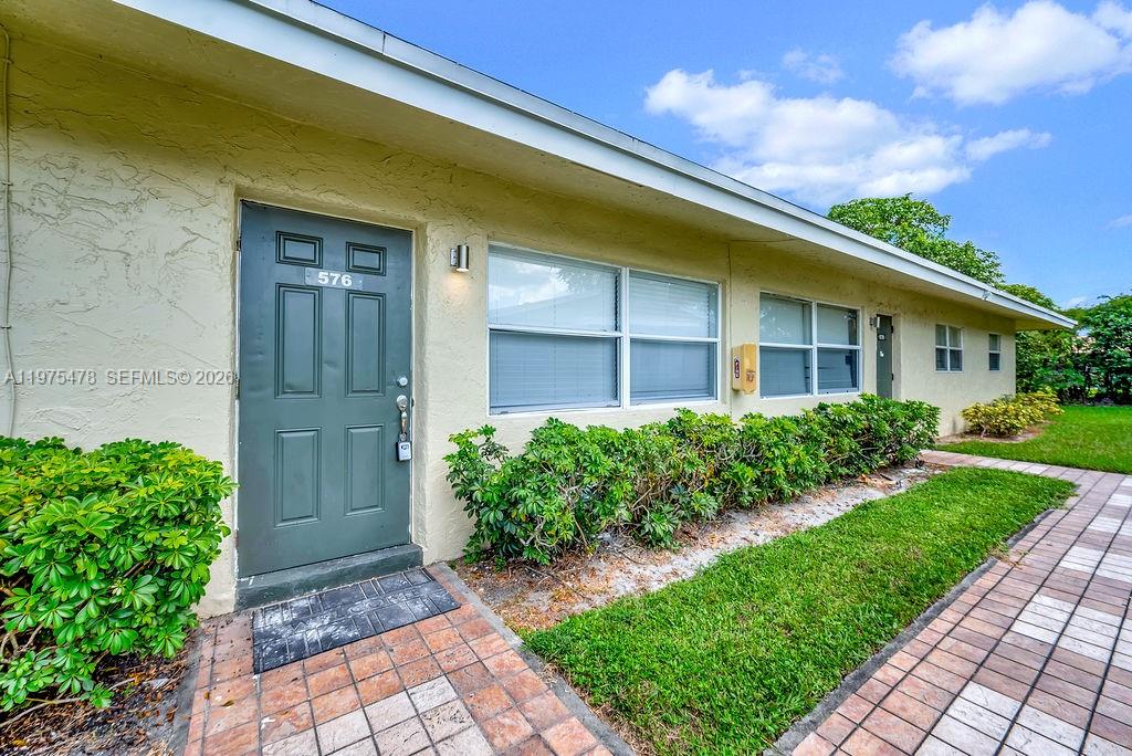 666 Kathy Court Pompano Beach, FL 33068 - Photo 42 of 45 a front view of a house with a yard