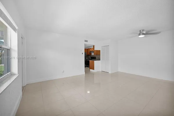 a view of empty room with furniture and window