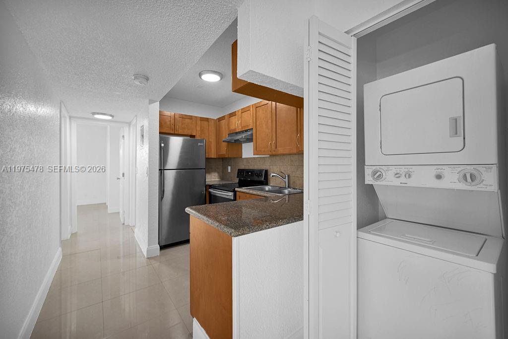 666 Kathy Court Pompano Beach, FL 33068 - Photo 10 of 45 a kitchen with refrigerator cabinets and a sink